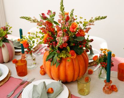 A pumpkin vase filled with seaonal florals
