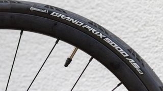 A black Continental Grand Prix 5000 AS TR tyre mounted to a black carbon rim