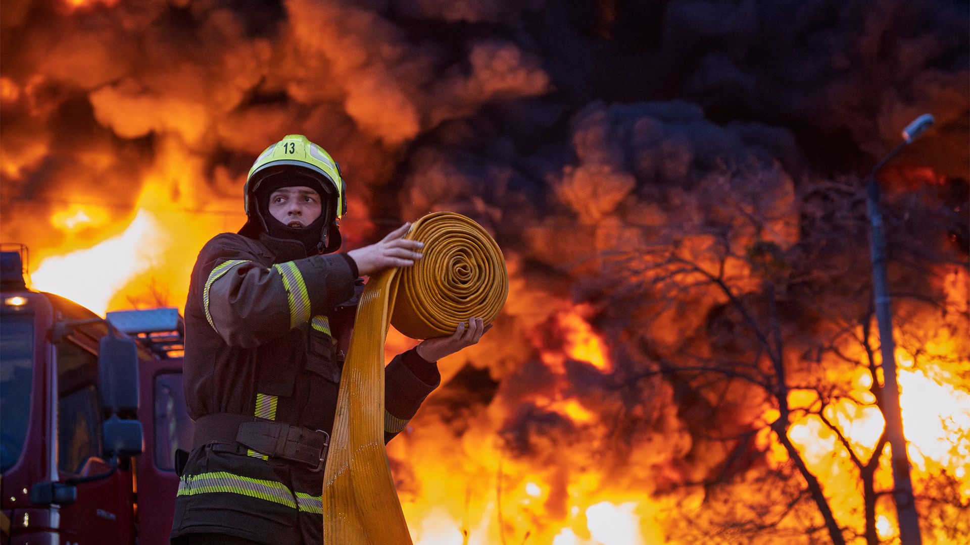 
                                A firefighter works to extinguish a blaze following a Russian strike in Kyiv, Ukraine
                            