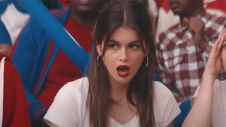 Kaia Gerber looking shocked on the bleachers in Bottoms.