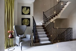 a beautiful staircase lighting idea with a pendant light dropping between storeys