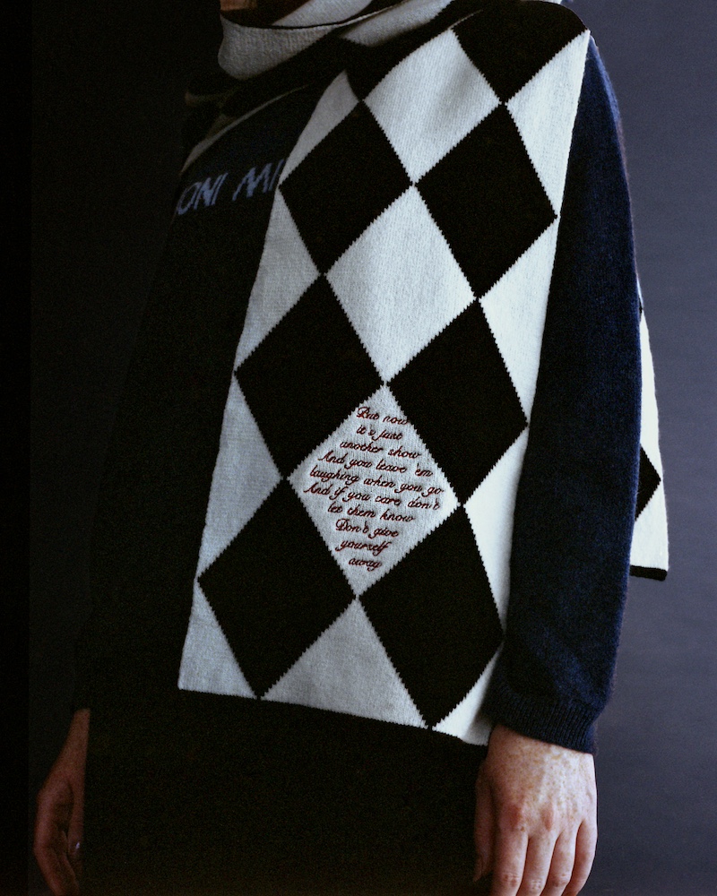 a close up of a black and white scarf from hades x joni mitchell collection