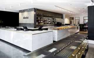 Large white marble-effect shop counter with sweets displayed and the bibelot logo