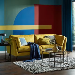 Yellow sofa in blue and red living room