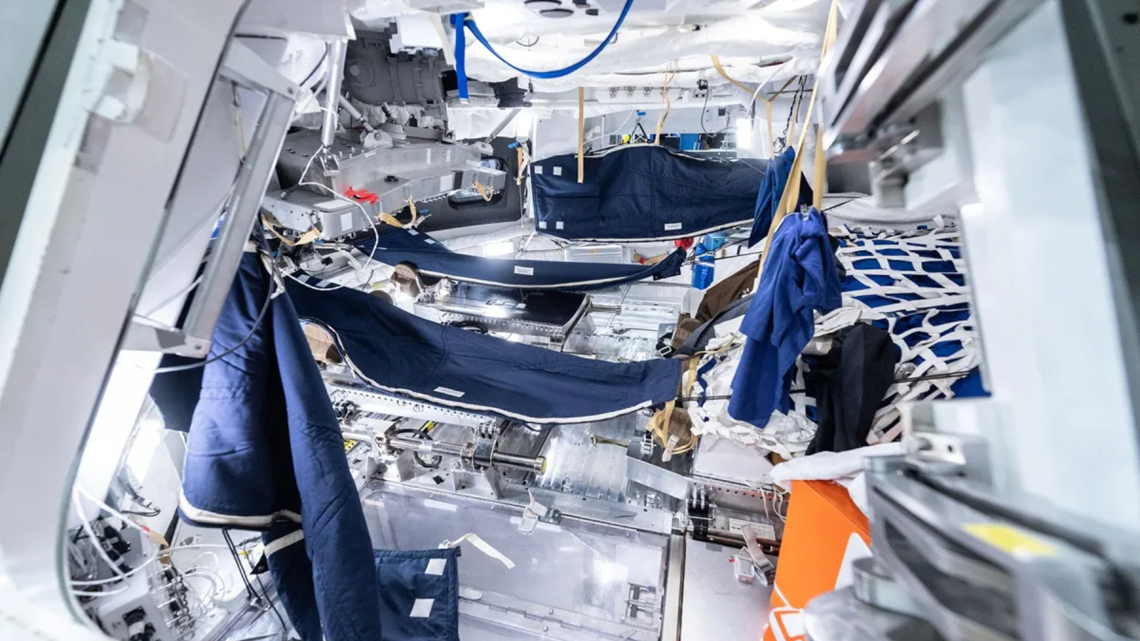 A photo of the sleeping section of the Orion capsule, showing the sleeping bags that the Artemis II crew will sleep in