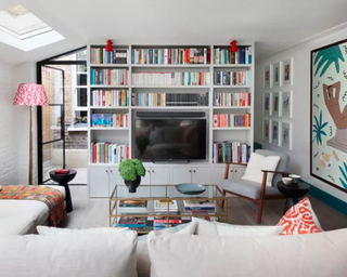 Library room with a TV hidden within a media unit