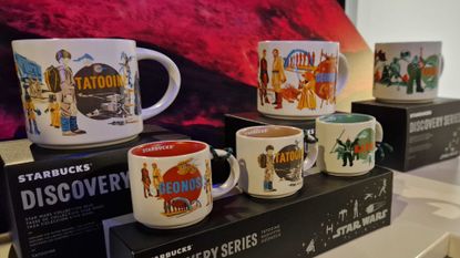 A collection of Starbucks Star Wars mugs on black boxes