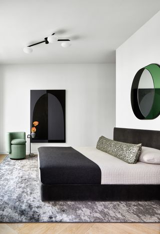 a modern bedroom design with green accents