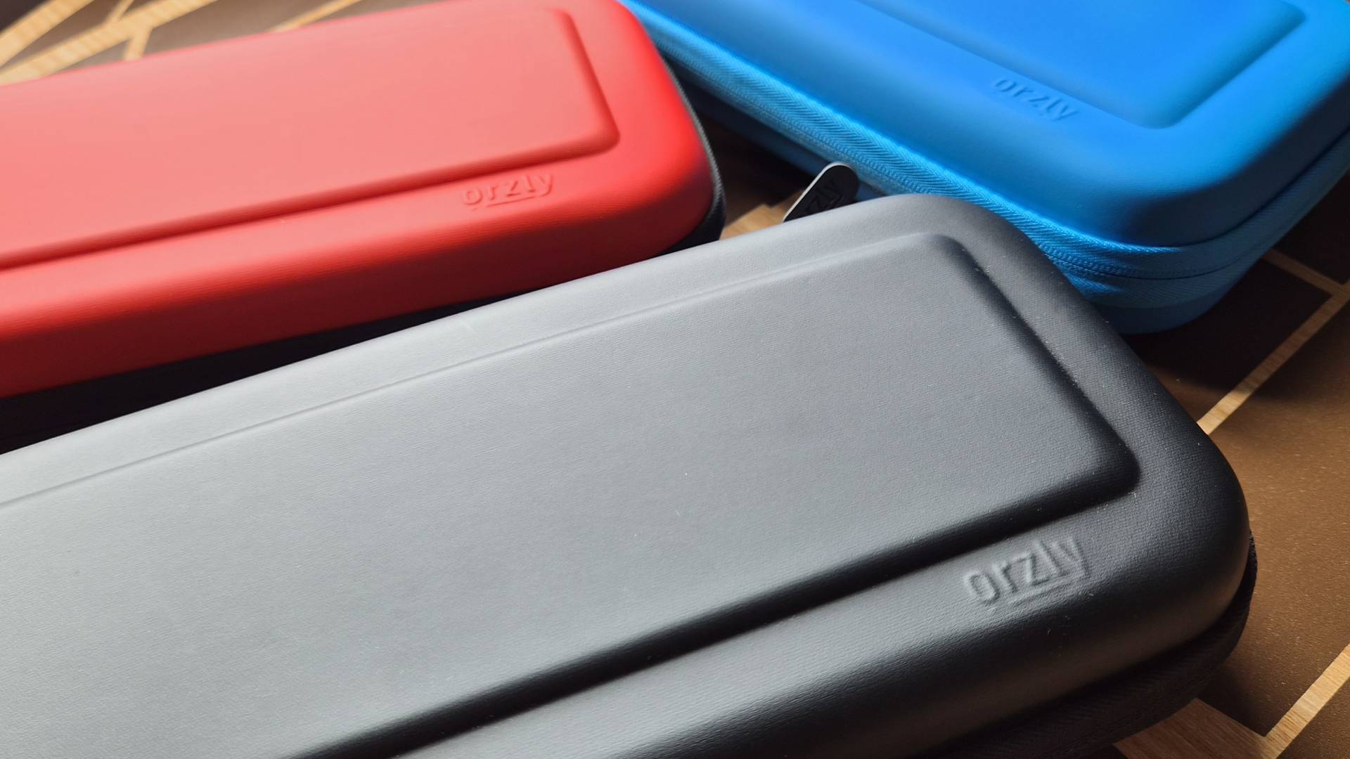 Photo of three Orzly Carrying Cases for Nintendo Switch 2 sitting on a table.