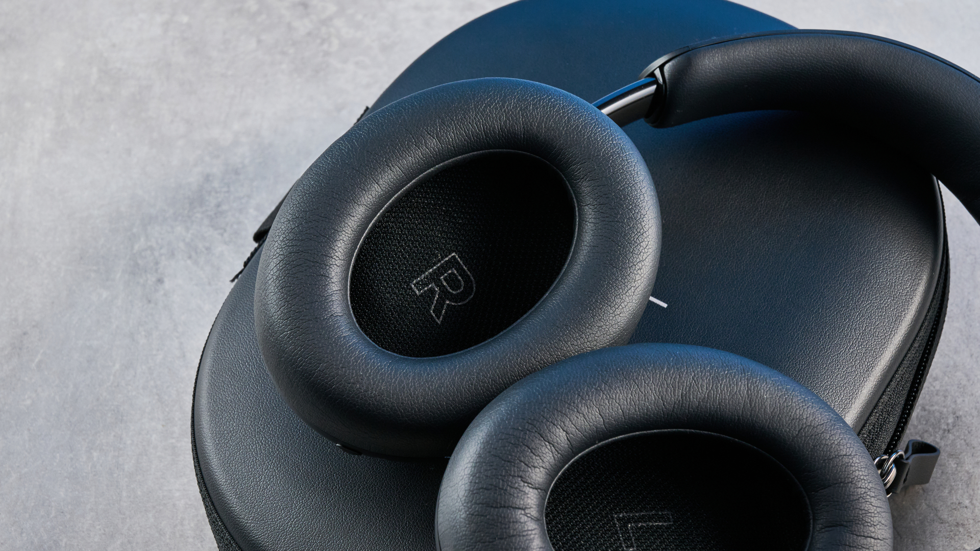 the bose quietcomfort ultra gen 2 headphones in black photographed on a blue tom's guide background