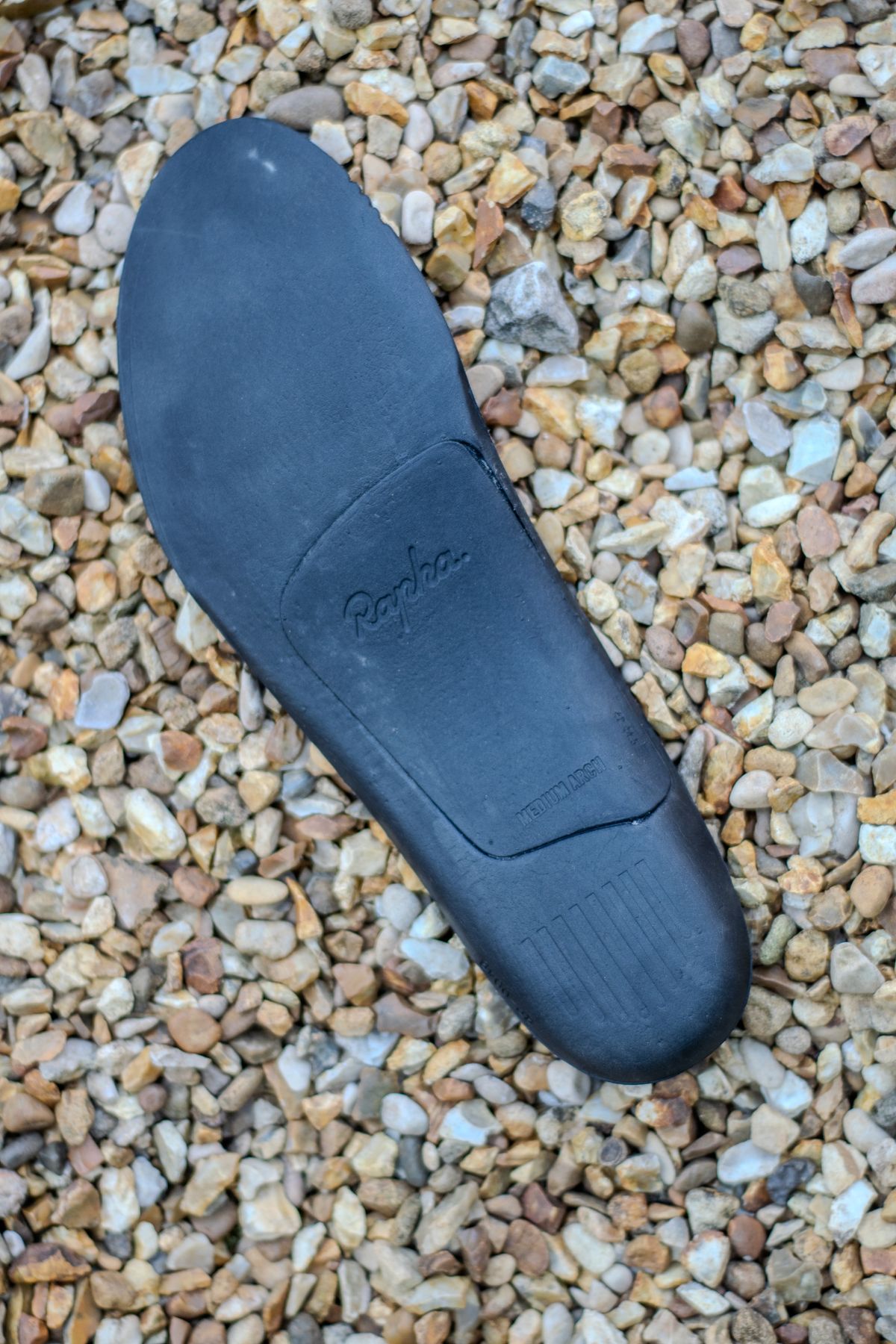 A Rapha Pro Team Gravel shoe on some gravel