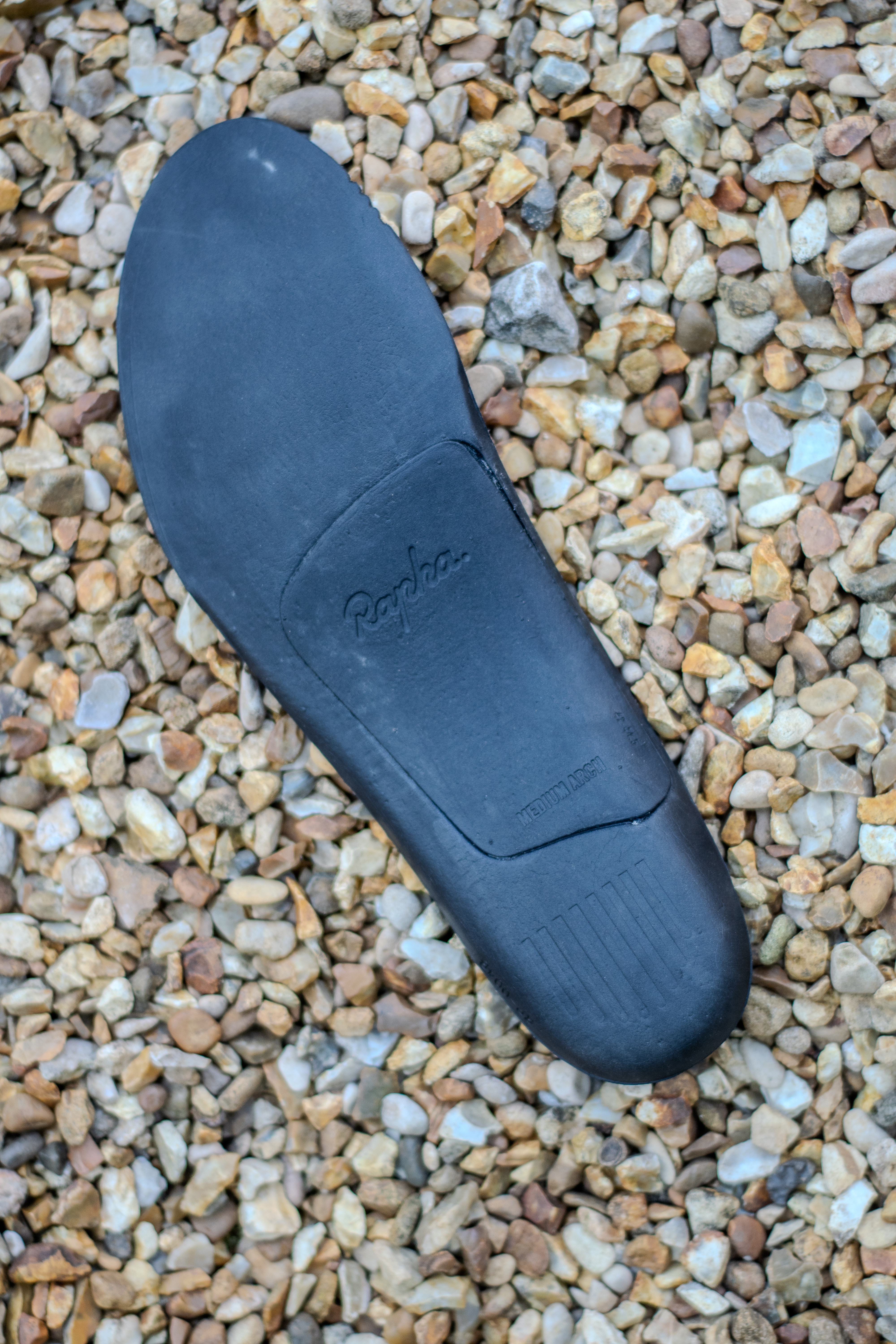A Rapha Pro Team Gravel shoe on some gravel