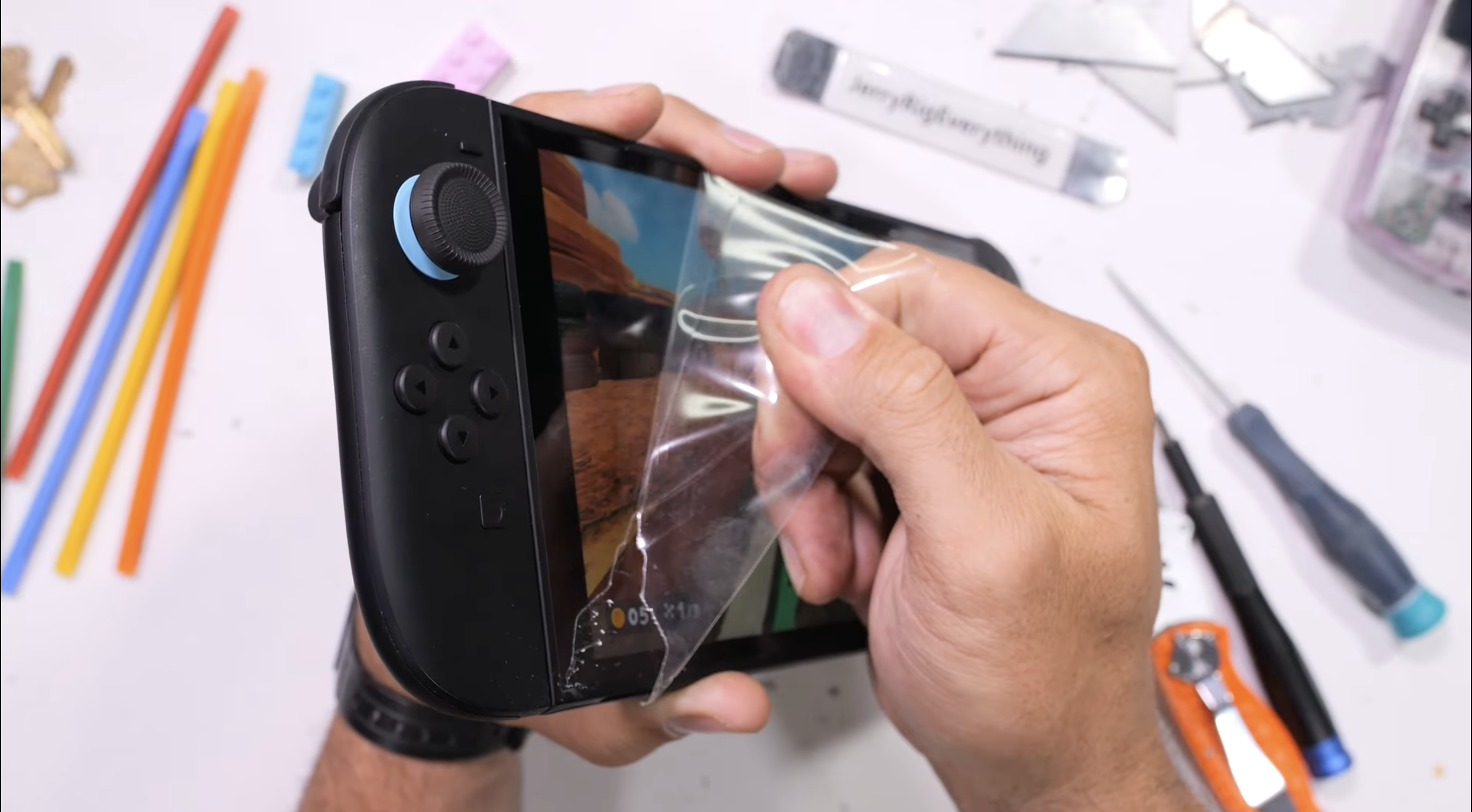 YouTuber peeling off the Switch 2's protective film.