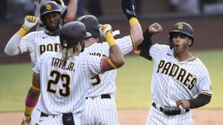  Trent Grisham (right) of the San Diego Padres is congratulated by Jake Cronenworth and Fernando Tatis Jr. after hitting a three-run home run Aug. 22,