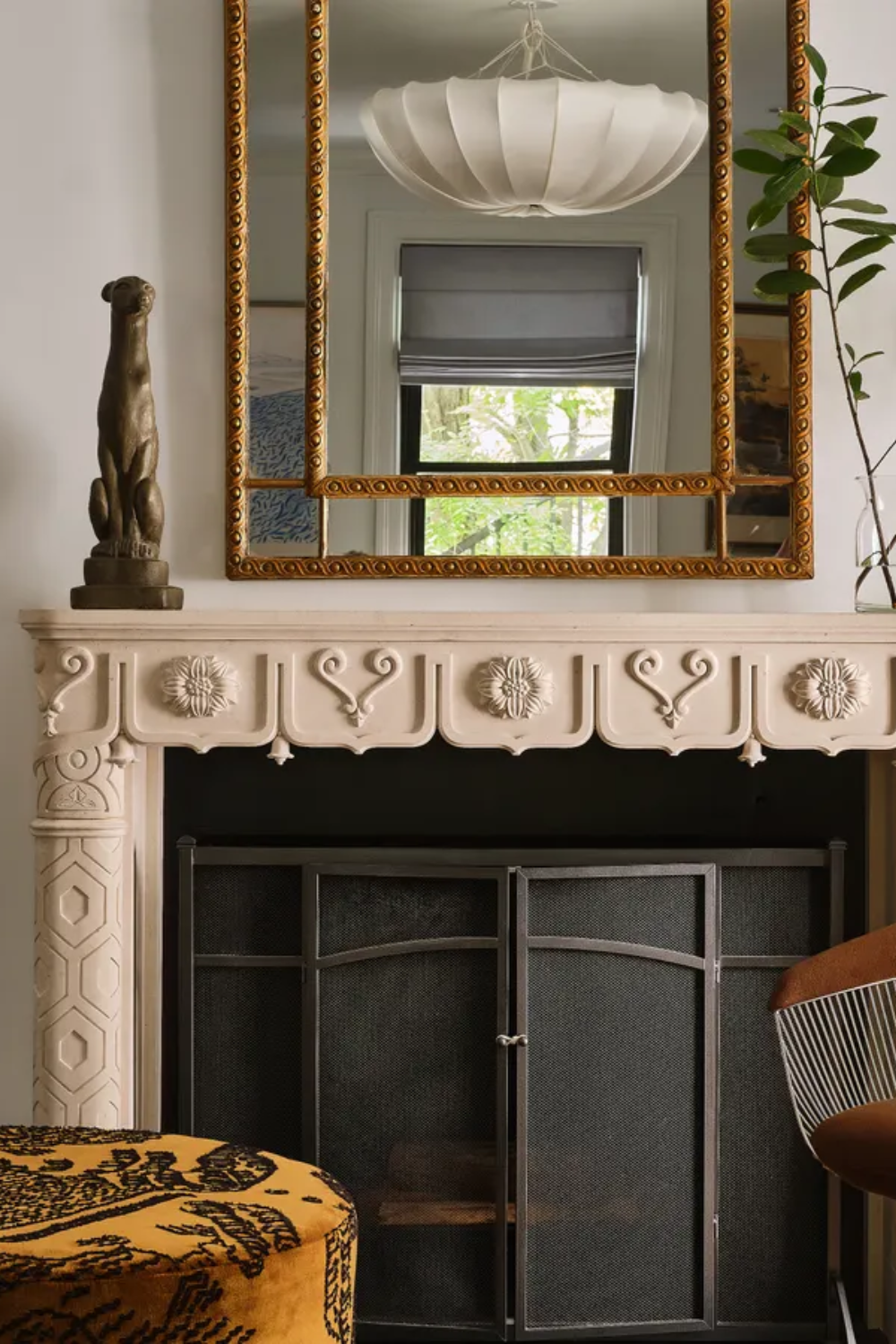 living room with modern chair and ornate fireplace