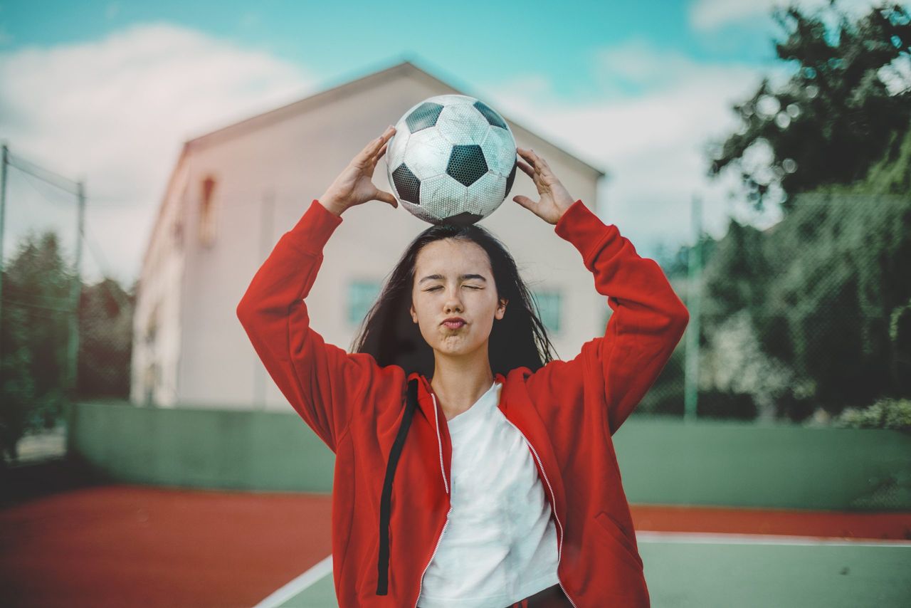 woman holding football