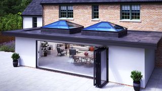 Korniche roof lanterns and bi-folding doors on large contemporary extension with large patio in front