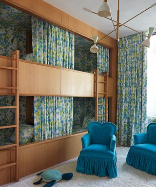 A child's room with a bunk bed and fabric curtains surrounding it