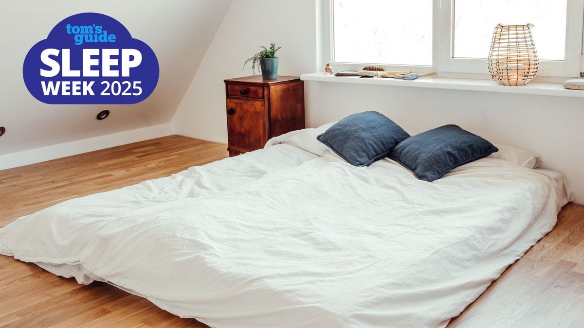 A mattress placed on a wooden floor with a Tom&#039;s Guide Sleep Week 2025 logo in the top left corner