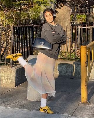 Fashion influencer and stylist Michelle Li wearing chic fall footwear with socks.