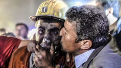 A man kisses his rescued son