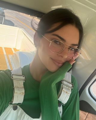 Kendall Jenner wearing white overalls and a green long sleeve shirt to pottery class Instagram update July 2024