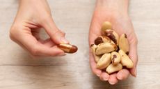 a woman holding brazil nuts