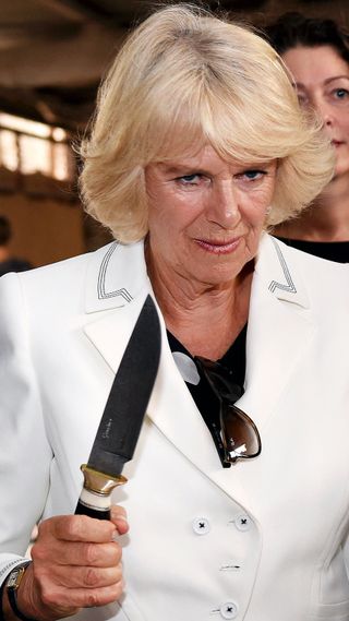 Camilla, Duchess of Cornwall holds a knife as she visits Seppeltsfield Winery