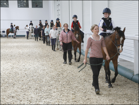 The children enjoy their riding lesson at Aintree International Equestrian Centre