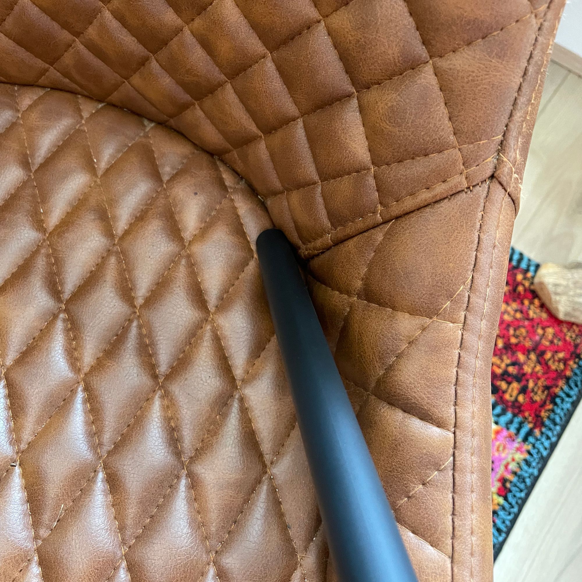 Using Dyson V16 Piston Animal crevice tool to vacuum leather chairs
