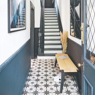 A hallway with Victorian mosaic tiled flooring