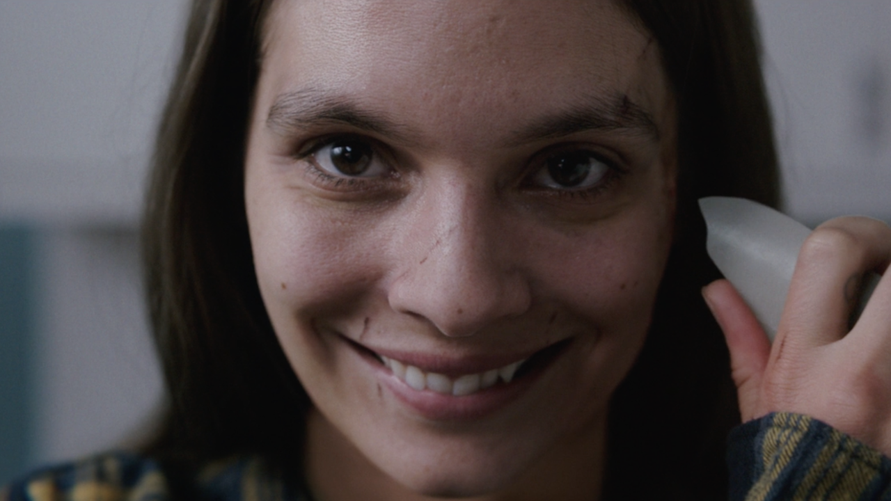 Caitlin Stasey as Laura Weaver smile death Smile 2022 movie