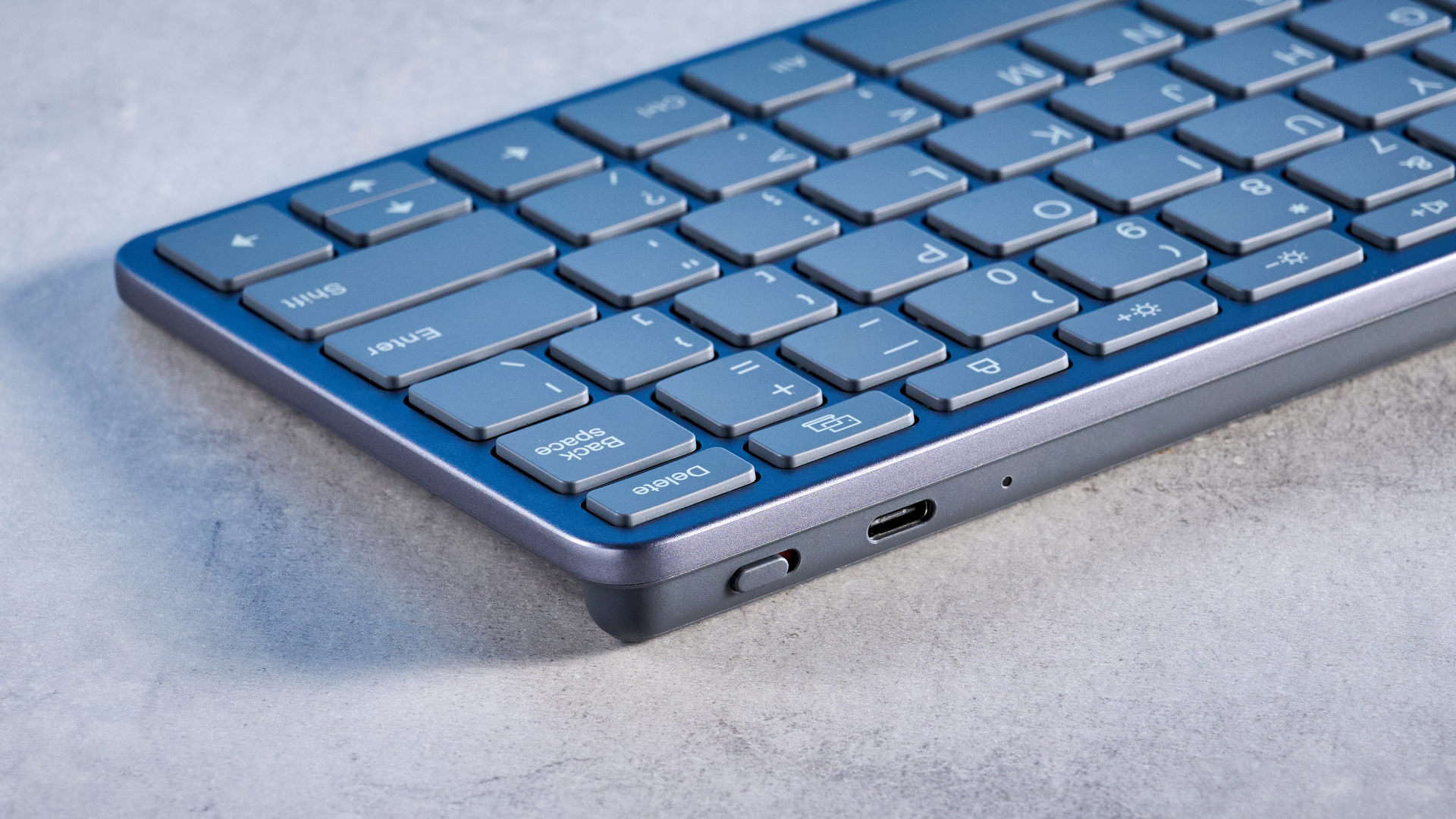 Lenovo Multi Device Keyboard photographed in front of a blue background.