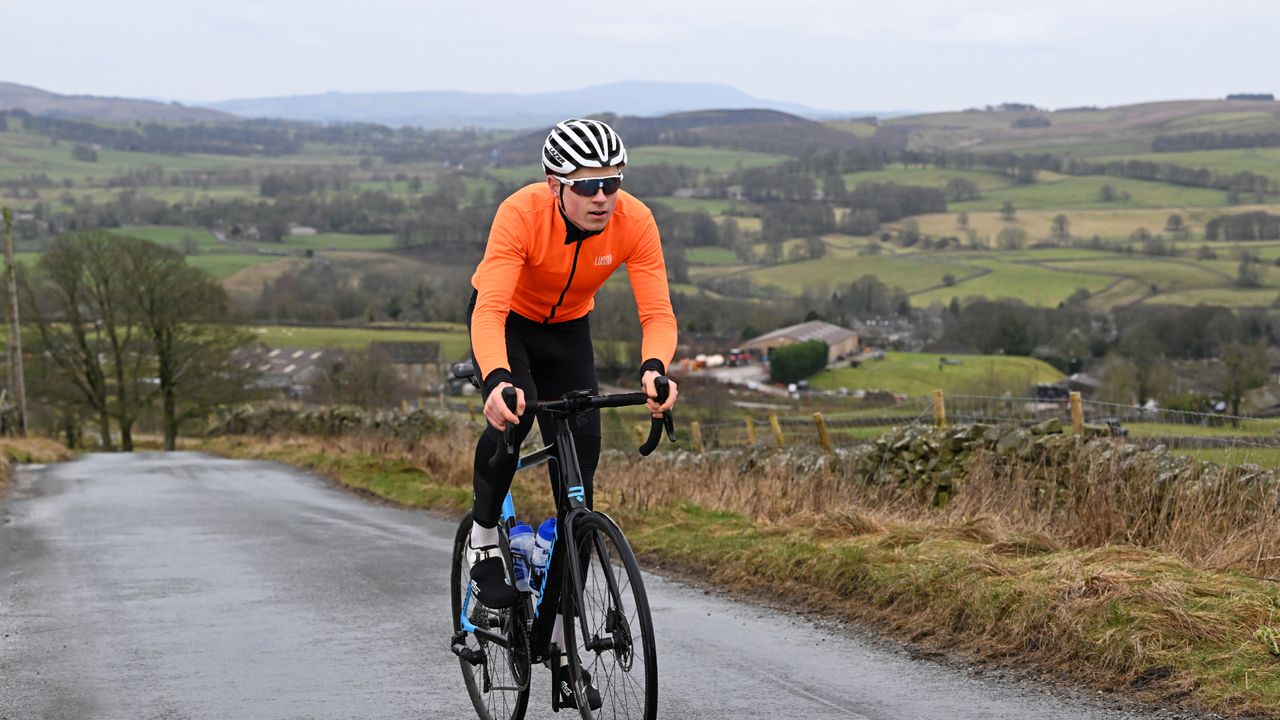 Male cyclist wearing one of the best winter jackets to keep warm while riding outside during the winter