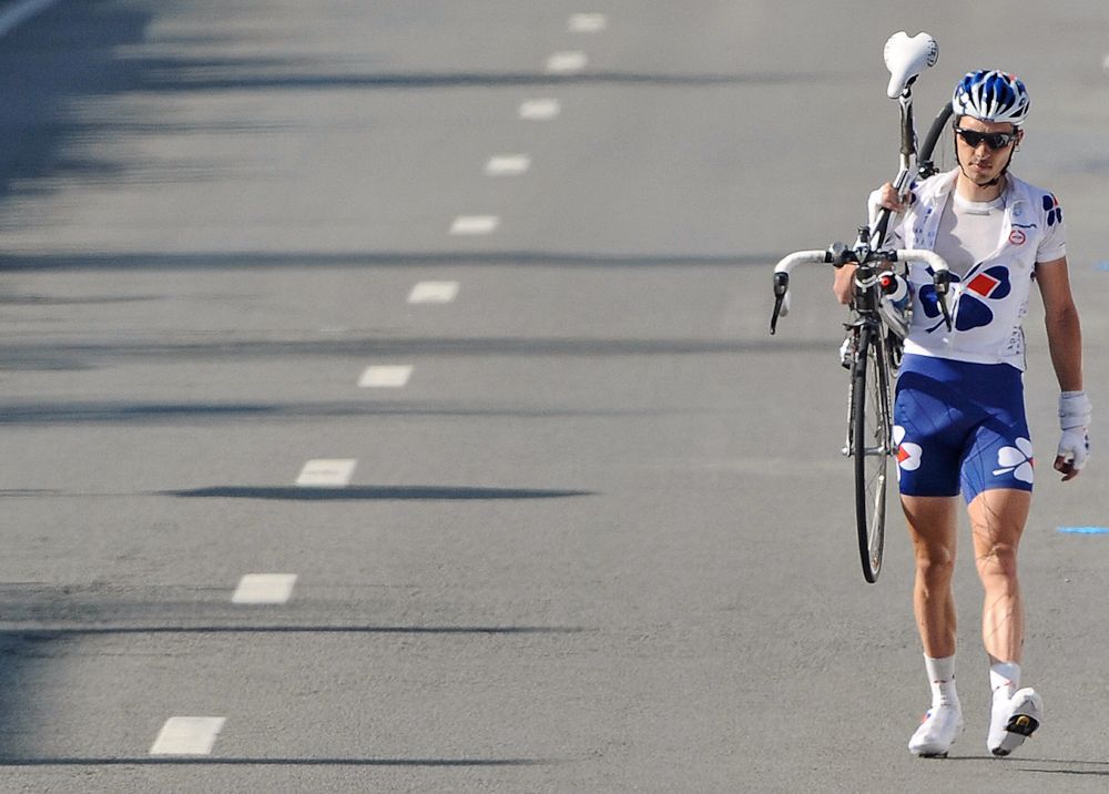 Anthony Geslin crosses the finish ligne walking and carrying his bike of the 93st Tour of Flanders on April 5, 2009.