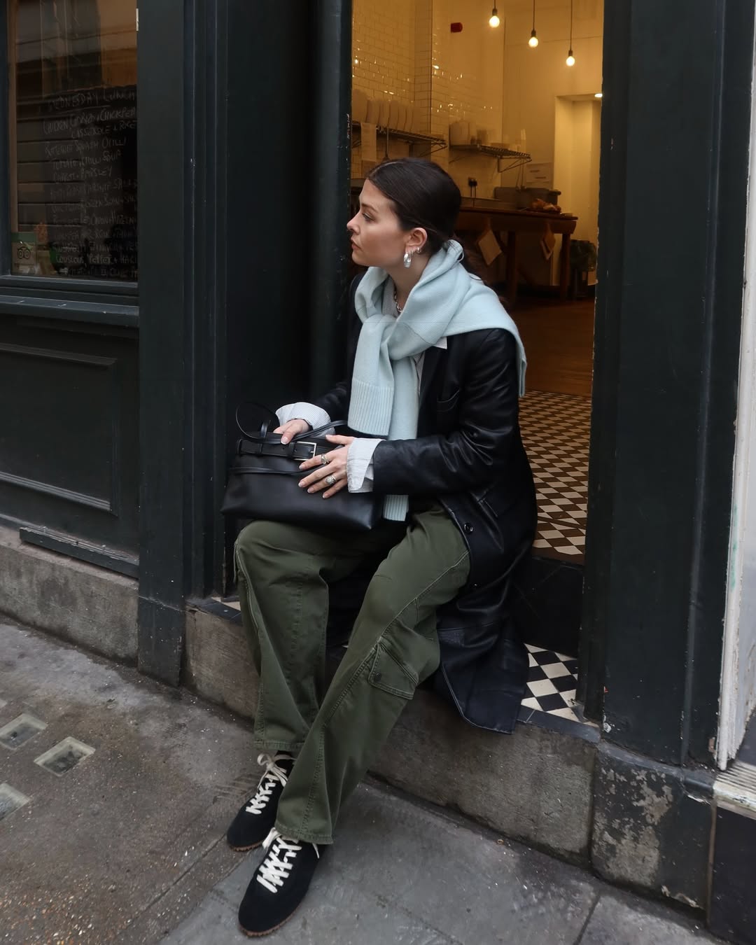 Influencer Alice Satterthwaite wearing black trainers.