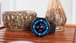 A OnePlus Watch 3 with a blue watchface