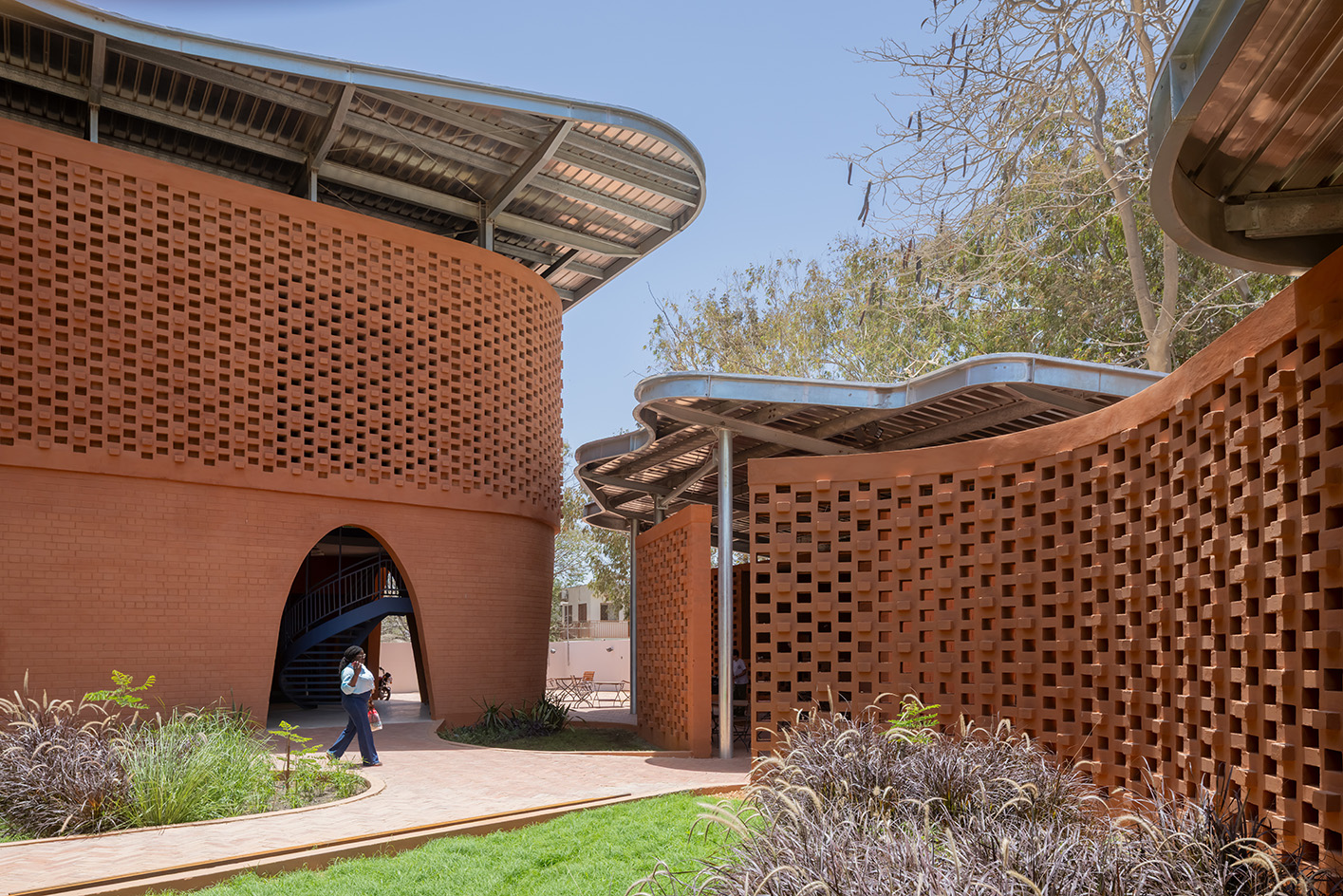 Goethe-Institut Dakar, brown earth block forms with wavy roofs designed by Francis Kere