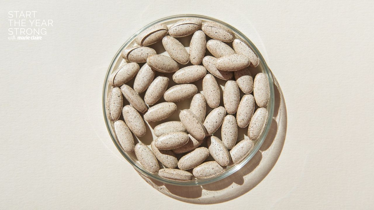 A bowl full of NMN supplements on a grey background