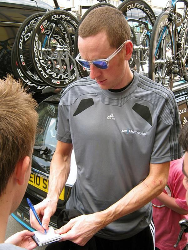 Stage one winner Bradley Wiggins (Sky) signs an autograph before the team time trial.