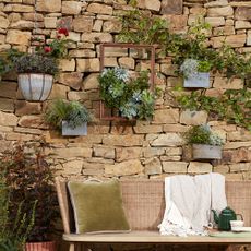 garden brick wall with wall planters and bench