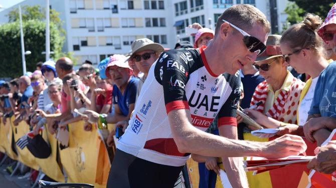 UAE Team Emirates' Dan Martin signs autographs for fans ahead of stage five