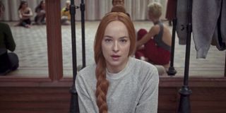 Dakota Johnson sitting on the floor in Suspiria