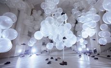 An image of shoes tied to balloons and which are floating in the Musée des Arts Décoratifs, Paris