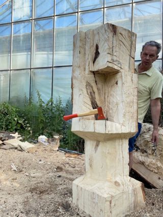 Tom Dixon working on wooden sculpture, with axe