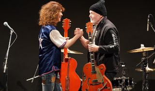 Takeshi (left) and Randy Bachman exchange guitars on July 1, 2022 in Tokyo, Japan