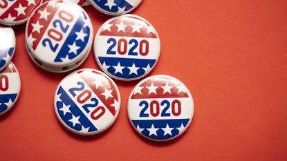 Stars-and-stripes-adorned 2020 election buttons against a bright red background