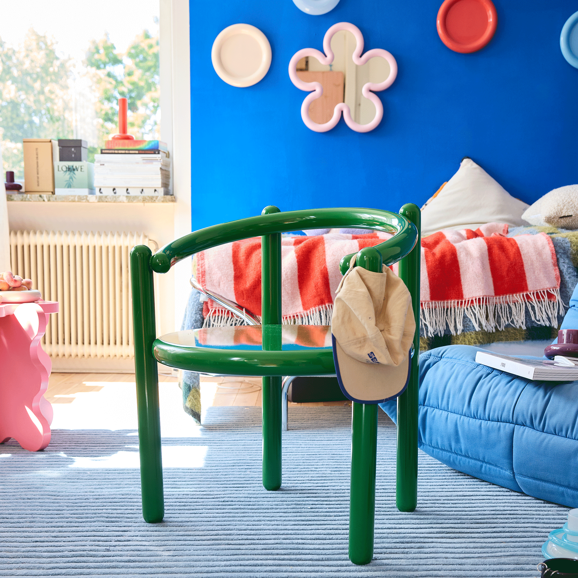 Gustaf Westman studio apartment, blue walls with mirror deco,r and green pipe chair