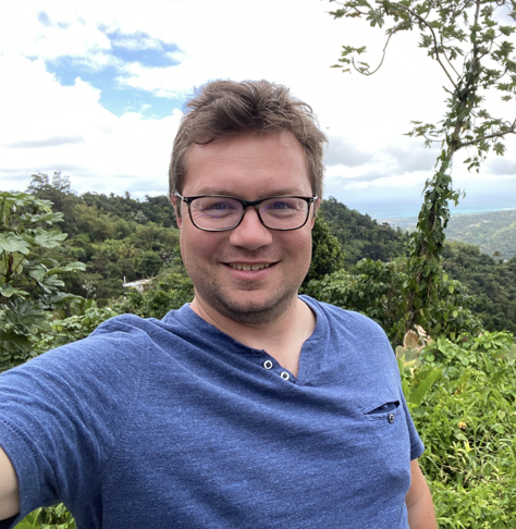 man wearing blue t-shirt smiling