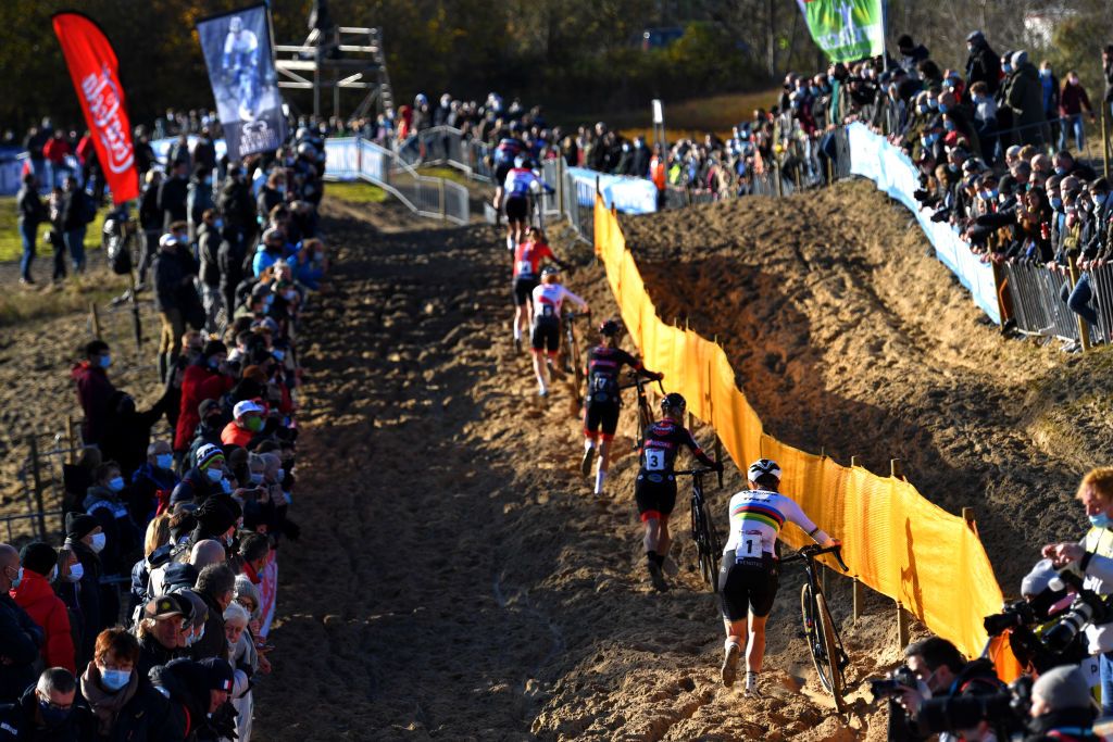 KOKSIJDE BELGIUM NOVEMBER 21 A general view of Denise Betsema of The Netherlands and Team Pauwels Sauzen Bingoal Lucinda Brand of The Netherland and Team Baloise Trek Lions and and the peloton compete while fans cheer during the 50th Koksijde UCI CycloCross Worldcup 2021 Womens Elite CXWorldCup on November 21 2021 in Koksijde Belgium Photo by Luc ClaessenGetty Images